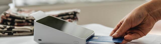 man inserting a credit card into the payment terminal