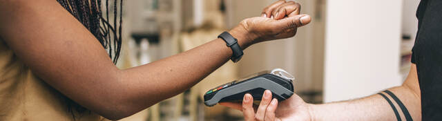 woman using a smartwatch for payment