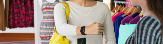 woman paying with smartwatch in store