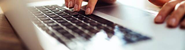 woman typing a laptop computer