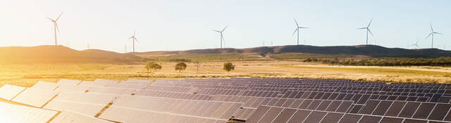 Sunrise on a solar and wind farm