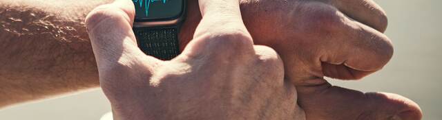 Man checking heart rate on a smart watch