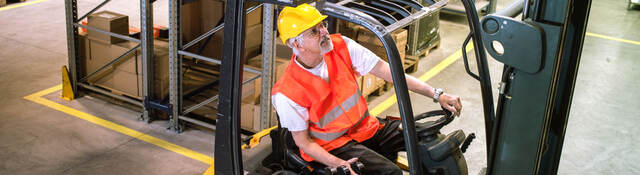 Worker driving a forklift