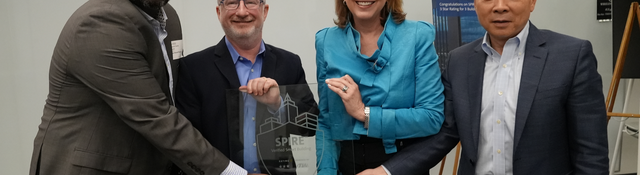 Microsoft and UL leadership hold a glass SPIRE Rating plaque