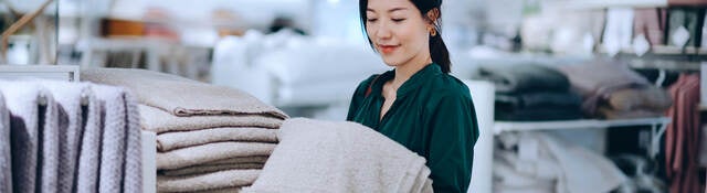 Asian woman shopping for bath towel