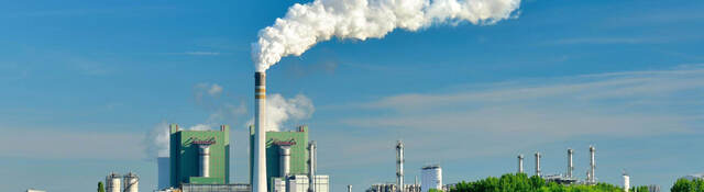 Steaming ignite-fired power plant in a green landscape