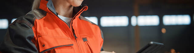 Engineer in PPE working on a tablet