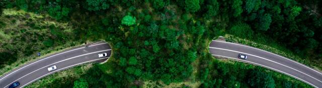 Aerial view of green bridge corridor for wildlife to cross highway safely.