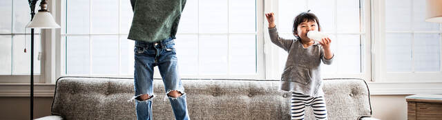 kids jumping on couch at home