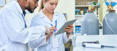 Researchers looking at data on a tablet