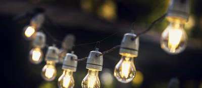 A strand of string lights in an outdoor setting. 