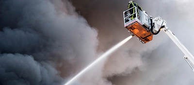 Firefighter spraying water on a fire