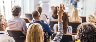 Business people attending a seminar in board room