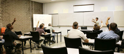 A classroom of individuals learns more about hazardous location training. 