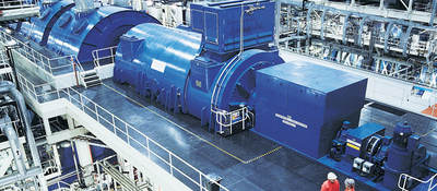 Two workers near an industrial generator in a warehouse setting