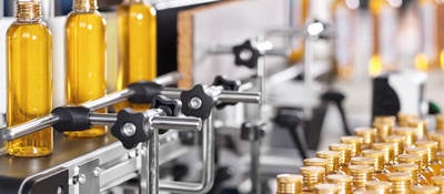 Bottles filled with liquid moving through the manufacturing process.