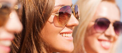 Three women wearing sunglasses