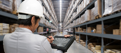 Man in hardhat w/ipad in warehouse w/H-frame