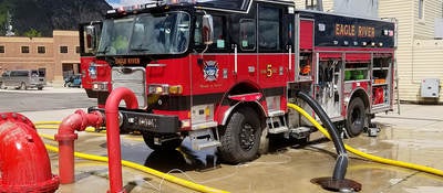 A parked fire truck receiving maintenance.