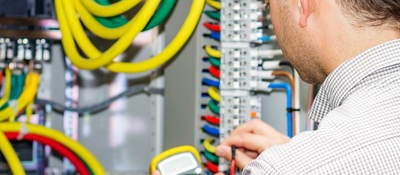 Electrical engineer working in electrical cabinet