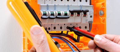 Electrician technician at work on a residential electric panel