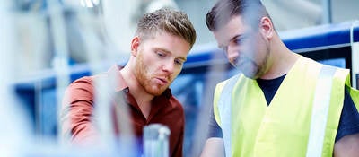 two young men conducting cable inspection for compliance