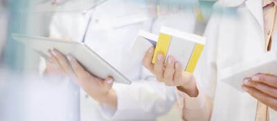 Pharmacists taking stock with digital tablet