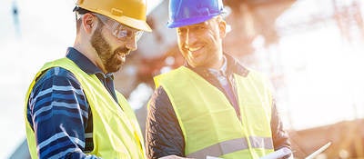 Two engineers smiling during inspection