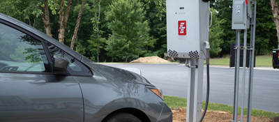 Image of silver electric vehicle and white bidirectional charger