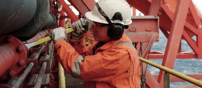 Working in a hard hat working in a petroleum refinery