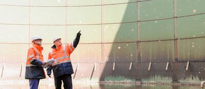 Technicians examining fuel storage tank