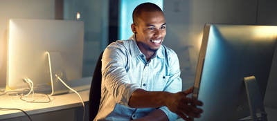 Shot of a young businessman working late in an office