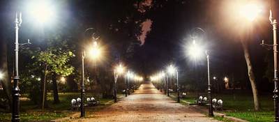 Park pathway lit up at night