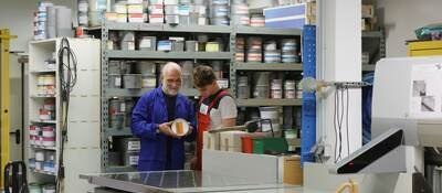 Workers looking at a paint can