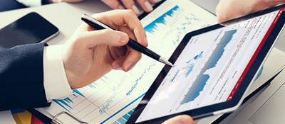 Image of two people’s hands holding a tablet, displaying Connect Analytics for Product iQ