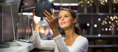 Women looking at desk lamps in a store