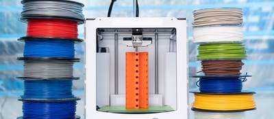 Spools of 3D printing filament and a 3D printer