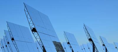 bifacial solar panels against a blue sky