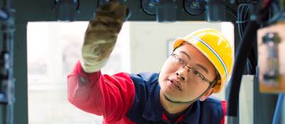 Person inspecting machinery