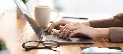 woman typing on a laptop keyboard