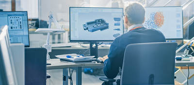 Industrial engineer works on his desktop monitors