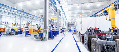 View overlooking the digitally controlled lighting of a brightly lit modern factory floor.
