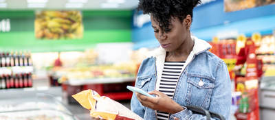 Woman scanning a label at the grocery store