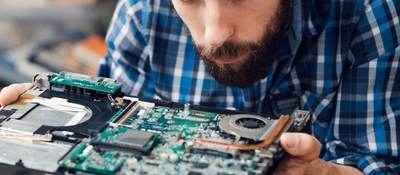 Engineer studying computer motherboard