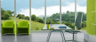 Glass desk with chair and view of the countryside through corporate windows.