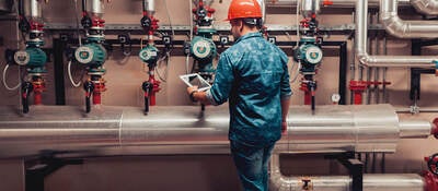 Electrical engineer working in an industrial boiler control room