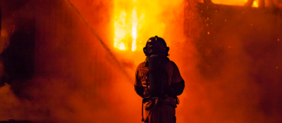 Firefighter and fire at night