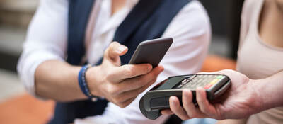 man using a mobile phone for payment