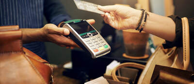 woman holding a credit card for payment