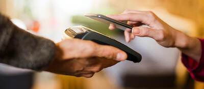 man tapping a mobile phone for payment